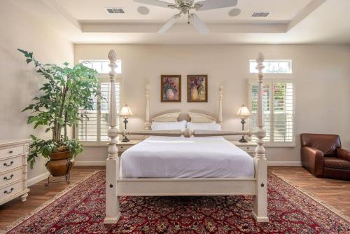 a bedroom with a white bed and a couch at The Fourteen at PGA West in La Quinta