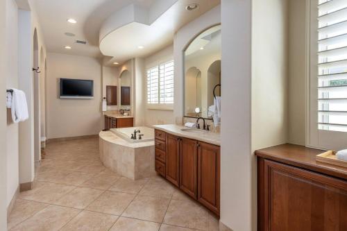a large bathroom with a tub and a sink at The Fourteen at PGA West in La Quinta