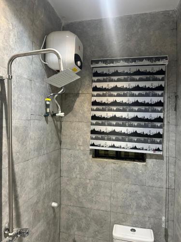 a shower in a bathroom with a shower curtain at Moor Times Hotel in Benin City
