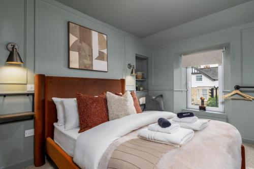 a bedroom with a large bed with towels on it at Caledonia Suite by The Wallace Monument in Stirling