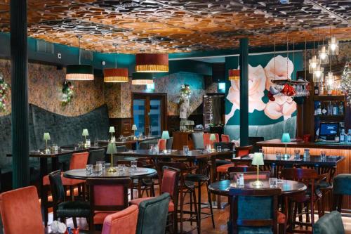 a restaurant with tables and chairs and a bar at Brogans Bar & Hotel in Trim