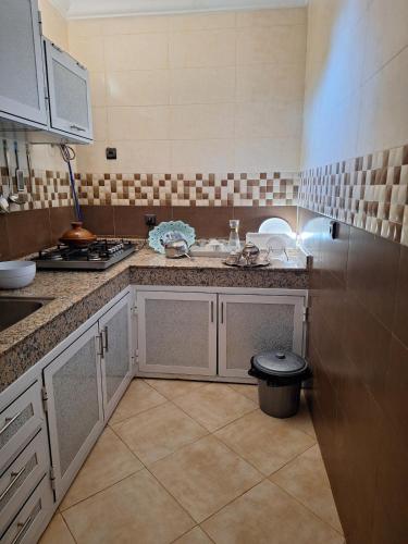 a kitchen with a sink and a counter top at Nawal's guest house in Tadouart