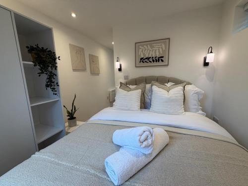 a bedroom with a bed with towels on it at Rosewell Lower Dicker in Horsebridge