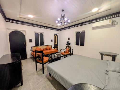 a bedroom with a bed and a desk and a piano at Nomada in Mount Ābu