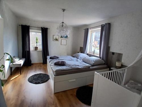 a small bedroom with a bed and a staircase at Haus am Seidelberg in Dürrhennersdorf