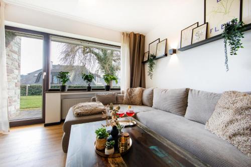 a living room with a couch and a table at Burgberg City Apartment in Daun