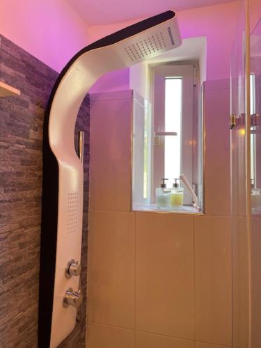 a bathroom with a shower with a mirror at 20 a Trieste in Trieste
