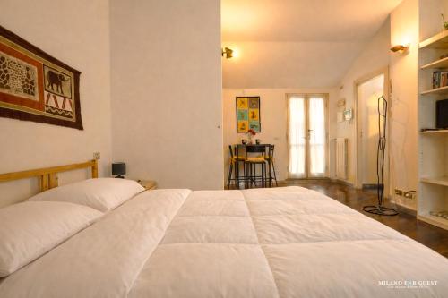 a bedroom with a large white bed in a room at The Central Milano in Milan