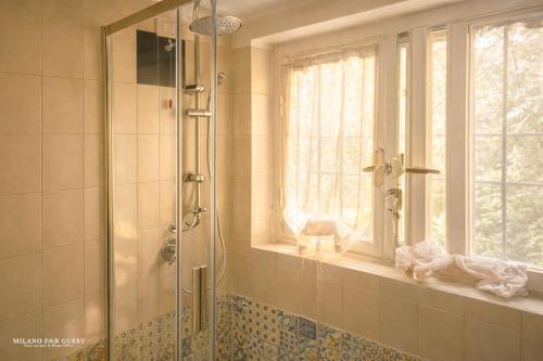 a bathroom with a shower with a window at The Central Milano in Milan