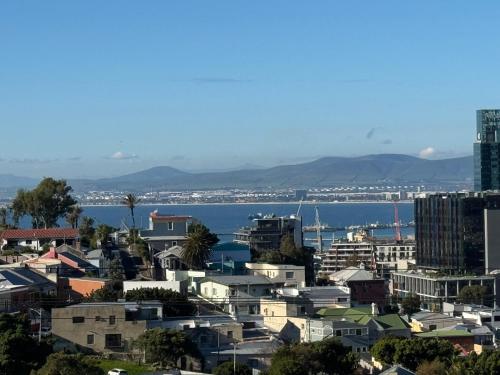 a city with buildings and the water in the background at Bo-Kaap Double Room with High Ceiling in Cape Town