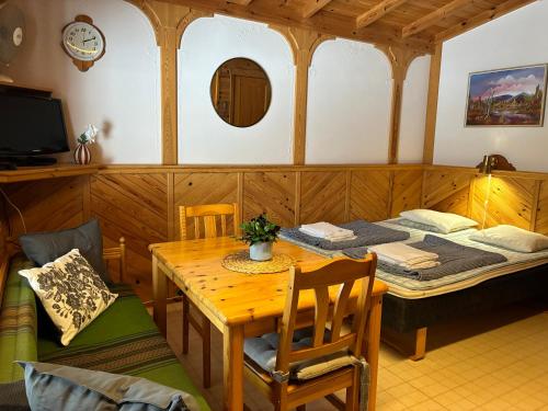 a room with a table and a bed in a room at Runneröd in Saltvik