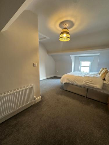 a bedroom with a bed and a light at Belles Haven in Belfast