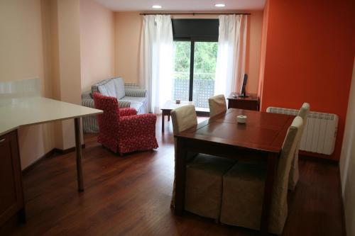 sala de estar con mesa y sillas y comedor en Apartaments Tarrega Lagranja, en Tàrrega