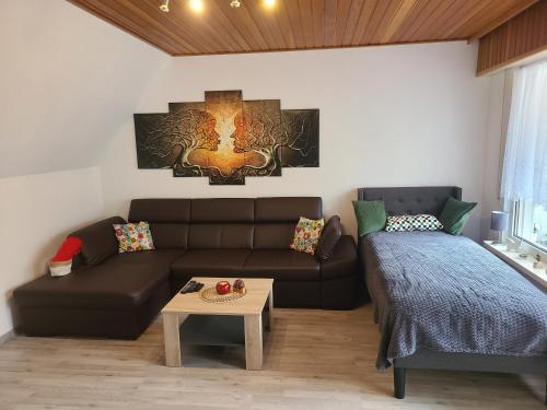 a living room with a couch and a table at FeWo Glücksmoment in Idar-Oberstein