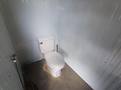 a bathroom with a white toilet in a room at S&A Camping in Ban Kum