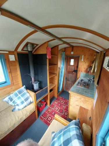 an aerial view of a bedroom and living room in a train car at EcoPod Holidays in Alton