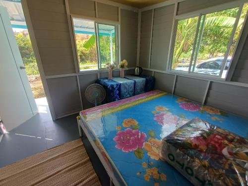 a small room with a bed and two windows at S&A Camping in Ban Kum