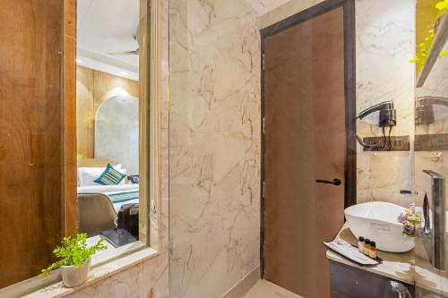 a bathroom with a sink and a mirror at Hotel Bella Express in New Delhi
