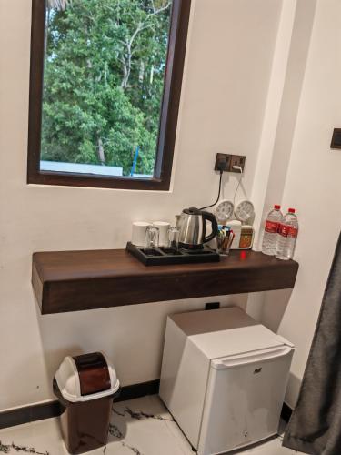 a kitchen with a counter and a window above a printer at Lake & Ocean Villa ahangama in Elagawagoda