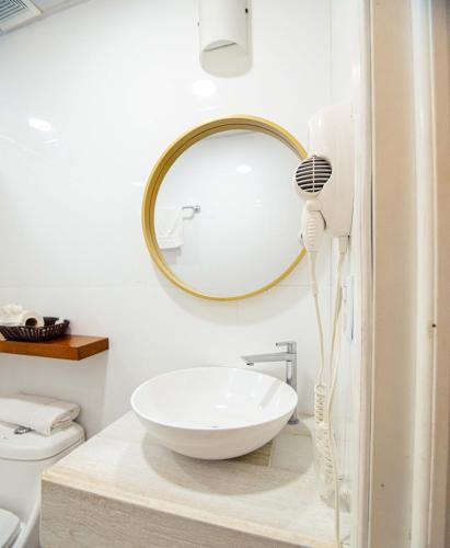 a bathroom with a sink and a mirror at Hotel Casa Turquesa in Flores