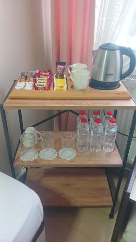 a wooden shelf with glass jars and a mixer on it at Arı Otel in Erzurum