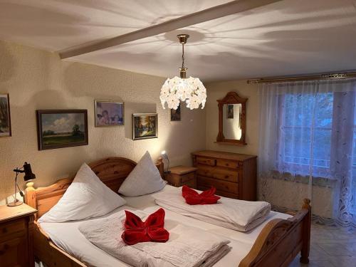 a bedroom with two beds with red bows on them at seeglueck Retro Am Münster in Konstanz