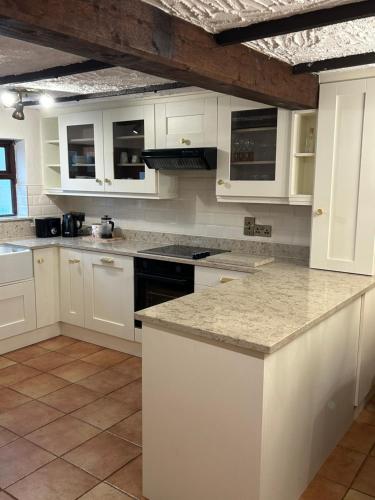 a kitchen with white cabinets and granite counter tops at NEW LISTING Faye’s Place in Donegal