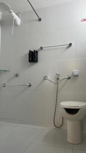 a bathroom with a shower and a toilet at Hotel Acalanto Feira de Santana in Feira de Santana