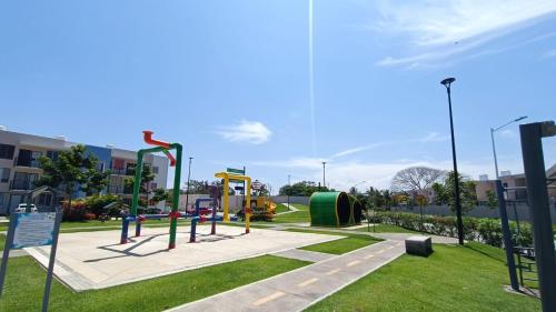 a playground in a park with at Cómodo y lindo departamento cerca de las playas in Mezcales