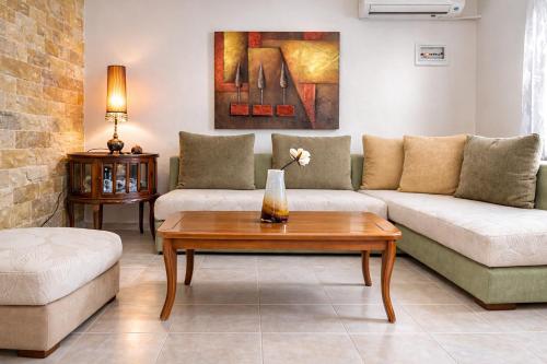 a living room with a couch and a table at Mola's Memories in Mola Kalyva