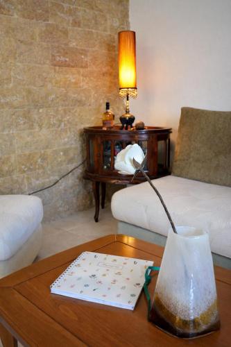 a living room with a table with a lamp and a couch at Mola's Memories in Mola Kalyva