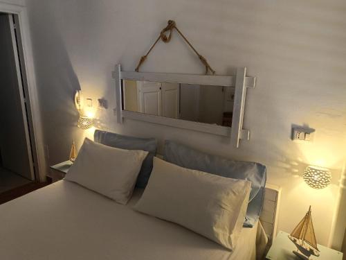 a bedroom with a bed with a mirror above it at B&B Casavecchia in Gallipoli