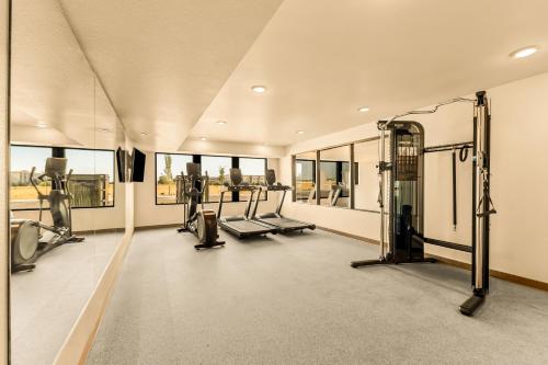 an empty gym with treadmills and elliptical machines at LivAway Suites Phoenix Tolleson in Phoenix