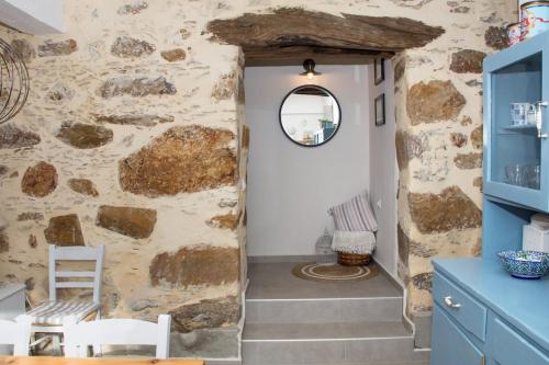 a hallway in a house with a stone wall at DOLONAS Cosy House in Aliyoí