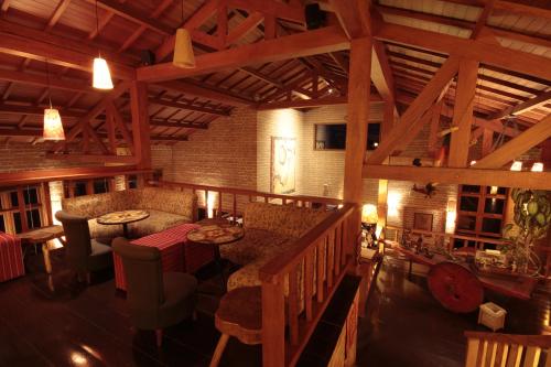 a large room with a bar in a building with wooden beams at Pousada do Quilombo in São Bento do Sapucaí