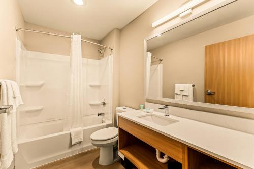 a bathroom with a sink and a toilet at LivAway Suites Phoenix Tolleson in Phoenix