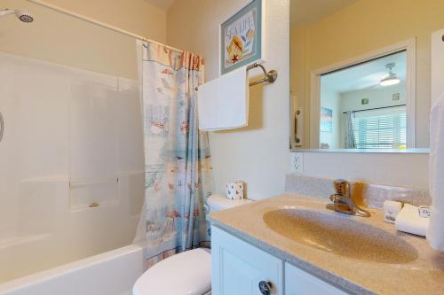 a bathroom with a sink and a toilet and a shower at HADS814 Wahoo 814 #102DS-H in Hatteras