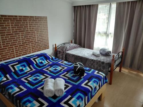 a bedroom with two beds and a brick wall at VISTALMONTE in Salento