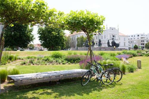 a bike parked next to a bench in a park at Best Western Hotel Tulln in Tulln