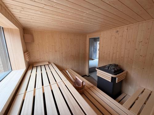 a inside of a wooden sauna with a trash can at Rurtal de luxe in Simmerath