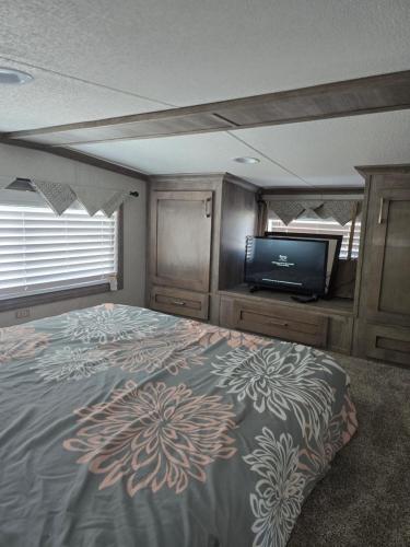 a bedroom with a bed and a flat screen tv at Marina View Cottage at Key Largo in Key Largo