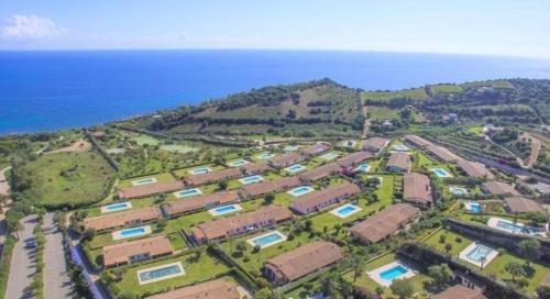 an aerial view of a campus near the ocean at Villino Giò - Residence Abba Urci in Tertenìa