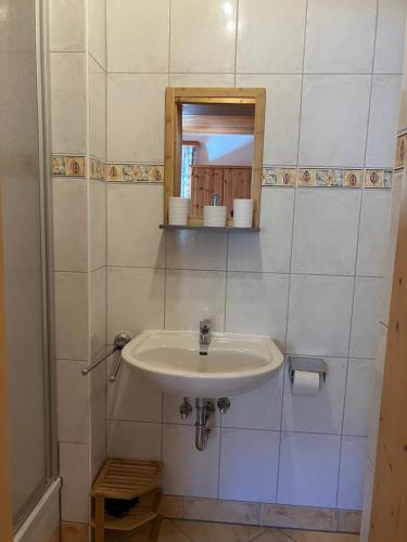 a bathroom with a sink and a mirror at Bio-Ferienhof Hotz in Spital am Pyhrn