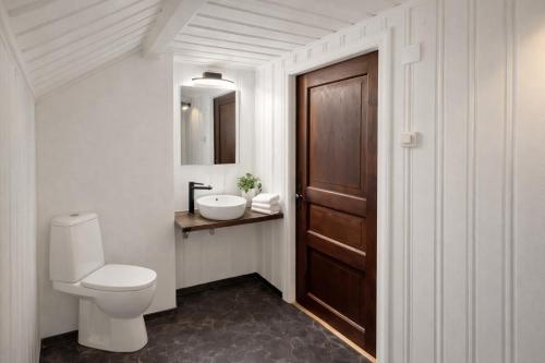 a bathroom with a toilet and a sink at Lilla Röda Huset. in Sjötofta