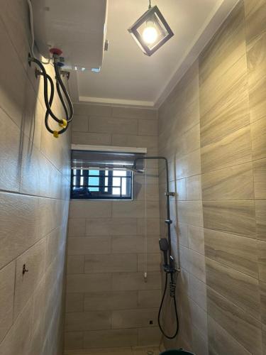 a bathroom with a shower with a toilet and a light at Happy Home in Trofwi
