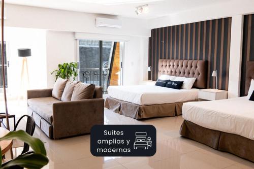 a hotel room with two beds and a couch at La Cisterna by DOT Suites in Buenos Aires