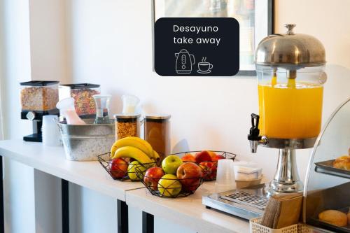 a table with fruit and a drink on it at La Cisterna by DOT Suites in Buenos Aires