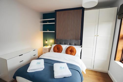 a bedroom with a bed with two towels on it at 4 Bed House in Central Derby with Parking WiFi Smart TV in Derby