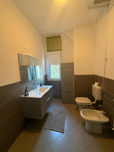 a bathroom with a sink and a toilet at Dimora delle Terme in Porretta Terme