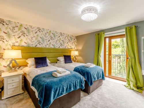 a bedroom with two beds and a window at 5 Bed in Durham oc-85257 in Lanchester
